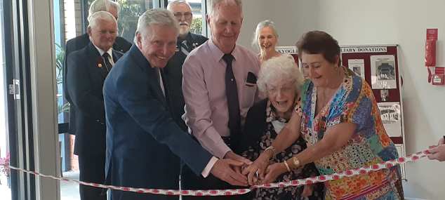 Health, community and MPS representatives cut a ribbon together