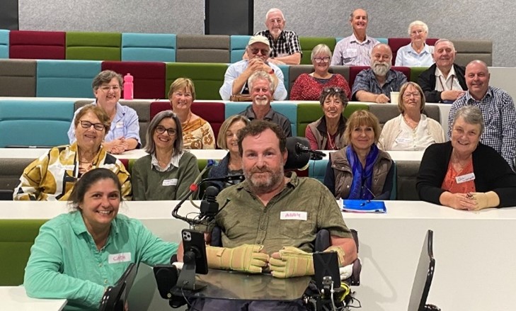 Community members sat in a meeting environment
