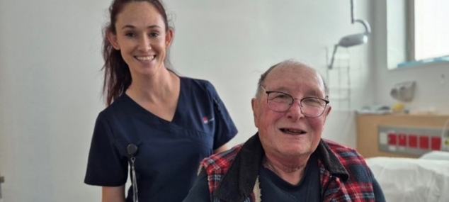 Elderly patient sat smiling with a nurse